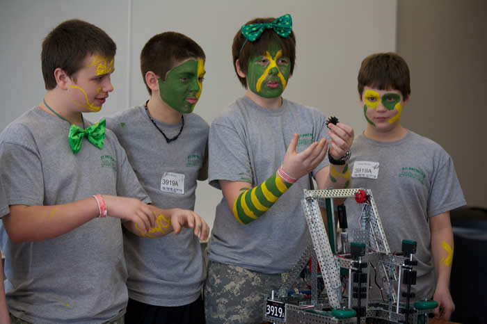Coaches and students collaborating in the pit